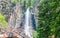 Scenic Palisade Falls flowing over steep cliff in a lush Montana forest