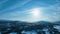 Scenic panning aerial panorama over Norwegian mountains from Swedish side of border. Frosty sunny winter day, blue sky with large