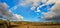 Scenic panorama of Tuscany countryside with full rainbow