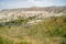 Scenic panorama unique rough stone and grass mountain landscape view of red and rose valley with sky background, Cappadocia