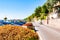 Scenic panoramic beltway road around lake Garda with medieval architecture buildings and rich northern Italy trees and plants