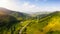 Scenic panoramic landscape. Aerial drone view of picturesque urban-type settlement in valley among green nature, coniferous