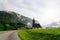 Scenic panoramic view of idyllic church in morning in the alps. Beautiful foggy morning scenery in Alps region, Austria. Great