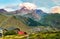 Scenic panoramic view of Kazbek mountain Georgia highest point and Gergeti Trinity Church at Stepantsminda village