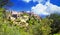 Scenic panoramic view on medieval picturesque old french village on hill top, blue summer sky, fluffy clouds - Gordes, Provence,