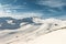 Scenic panoramic view of Silvretta ski area at Iscgl and Samnaun skiing resort with chairlifts , downhill slpoes and clear blue