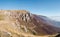 Scenic panoramic view of the steep rocky cliffs of Mount VlaÅ¡iÄ‡ and the valley filled with fog in autumn during a sunny day