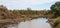 Scenic panoramic view from Sweni bird hide of the river landscape with birds and hippo in the distance