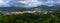 Scenic panoramic view of a village in mountain valley at sunset. Colourful countryside landscape with mountain