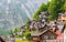 Scenic picture-postcard view of famous Hallstatt mountain village in the Austrian Alps with passenger ship in beautiful morning l