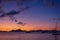 Scenic purple sunset over sea in Philippines, Palawan. Island and boats silhouettes in evening dusk. Calm golden evening in Asia.