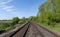 Scenic railway road running in green rural landscape