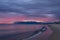 Scenic red sunrise over coastline with sandy beach and clear sea water in Alcamo Marina, small town in Sicily, Italy, summer