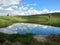 Scenic reflecting clouds in a little vulcanic lake landscape