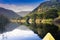 Scenic river reflections with river edge trees and mountains taken byfrom a canoe