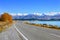 Scenic Road along Lake Tekapo at beautiful sunny morning . Lake Tekapo and mountains with snow in autumn, Canterbury, South Is