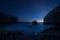 Scenic rocky seashore at sunset under the stars.