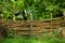 Scenic rural palisade fence garden outside landscaping object in summer time green foliage background environment