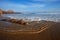 Scenic sandy beach with waves and blue sky