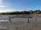 Scenic seascape, landscape view of low tide muddy swamp beach with mongrove forest and birdwatching tower and blue sky background