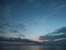 Scenic shot of clouds in the sky above the vast ocean during dusk