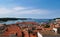 Scenic shot of the coastal town of Porec with red roof homes and the calm blue sea in Croatia