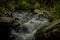 Scenic shot of a moody waterfall in a green jungle