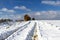 Scenic shot of a pair of tire tracks on the snowfield during winter