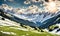 Scenic spring: Meadow with snowy mountains in background