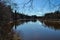 Scenic spring river view in forest with foliage tree leaf and low water with rocks and sand in stream