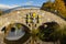 A scenic stone arched bridge on Carroll Creek with zodiac themed metal art decorations