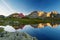 Scenic summer landscape shot in the mountain with hut reflection in a beautiful lake