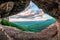 Scenic summer landscape view of Mezmay village from inside weird rocky grotto in Caucasus mountains, Lenina Rock shelf, Russia