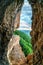 Scenic summer vertical landscape view of mountain forest from inside weird rocky grotto in Caucasus mountains, Lenina Rock shelf,