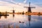 Scenic sunset landscape with windmill and sky, traditional dutch village of mills Kinderdijk, Netherlands