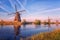 Scenic sunset landscape with windmill and sky, traditional dutch village of mills Kinderdijk, Netherlands