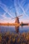 Scenic sunset landscape with windmill and sky, traditional dutch village of mills Kinderdijk, Netherlands