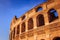 Scenic sunset over the Colosseum. Marble arches ruins over a blue sky, Rome, Italy