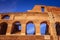 Scenic sunset over the Colosseum. Marble arches ruins over a blue sky, Rome, Italy