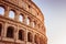 Scenic sunset over the Colosseum. Marble arches ruins over a blue sky, Rome, Italy