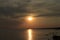 Scenic sunset over the sea. Reflection of the sun in water. The sky is painted with bright colors. Sunset beach in a summer