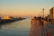 Scenic sunset view at Cesenatico Porto Canale. People are slowly strolling along the canal