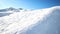 Scenic valley of hilghland alpine mountain winter resort on bright sunny day. Wintersport scene with people enjoy skiing