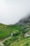 Scenic vertical shot of Armenian green-covered mounts in fog