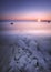 Scenic vertical shot of the coast of Galway City in Ireland facing the Atlantic Ocean during sunrise