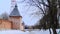 Scenic view of ancient brick wall with towers of old. Stock footage. Winter look of orthodox male monastery in Russian