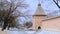 Scenic view of ancient brick wall with towers of old. Stock footage. Winter look of orthodox male monastery in Russian