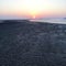 Scenic view of beach against sunset sky