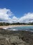 Scenic view of a beach with a brilliant blue sky and serene, sparkling turquoise water