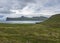 Scenic view on beautiful Hornbjarg cliffs in west fjords, remote nature reserve Hornstrandir in Iceland, with green meadow, flower